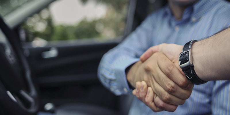 Spence GMC customer shaking hands with sales rep