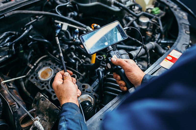 Spence GMC in Thomasville GA technician working on an engine
